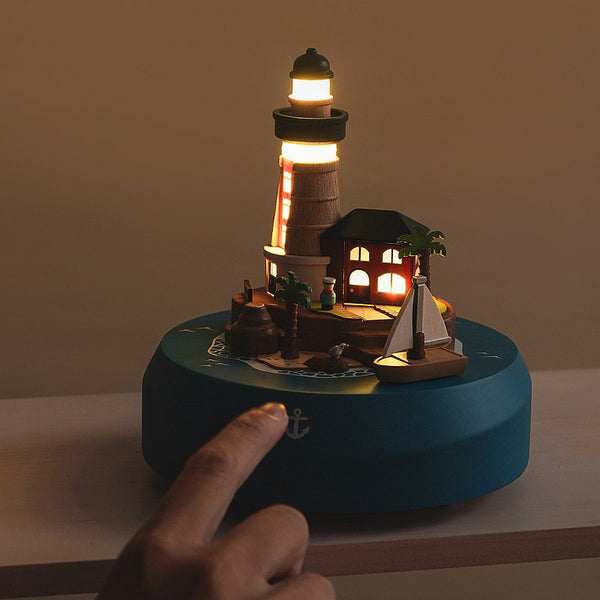 Lighted Lighthouse And Sailboat 